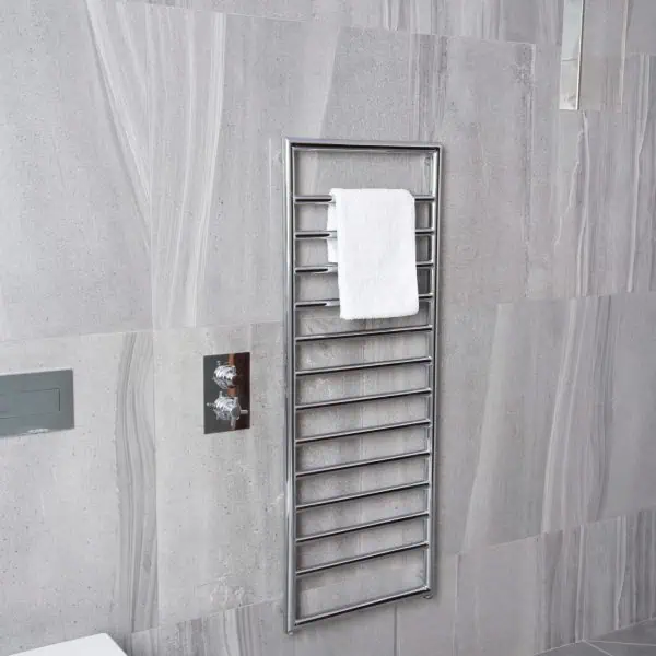 Chrome towel radiator heater in modern bathroom with gray tiles, heated towel rail for comfort.