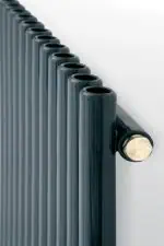 Black modern radiator with multiple vertical pipes for heating and home decor.
