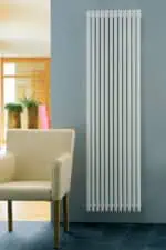 Modern white vertical radiator in contemporary home decor setting.