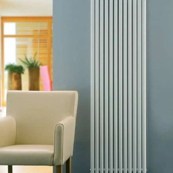 Modern white vertical radiator in contemporary home decor setting.