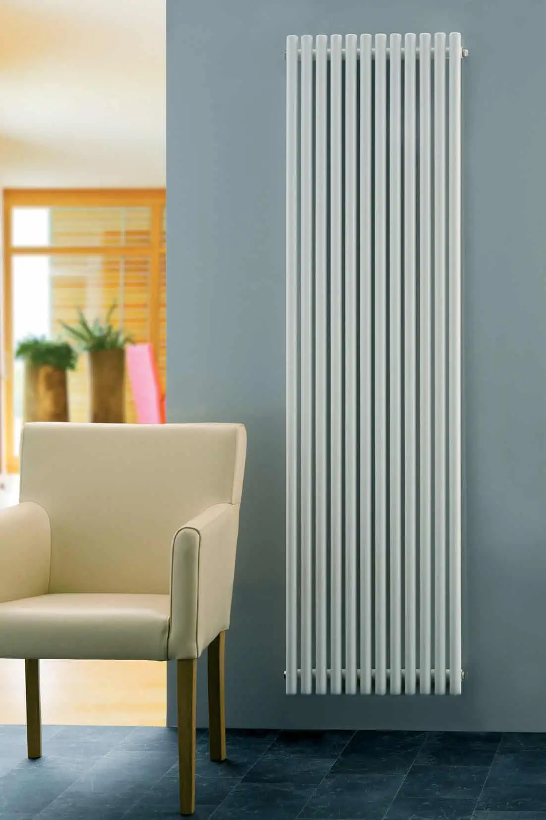 Supra-Round-White-1 Modern white vertical radiator in contemporary home decor setting.