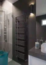 1. Modern black heated towel rail in contemporary bathroom with shower and sink.
