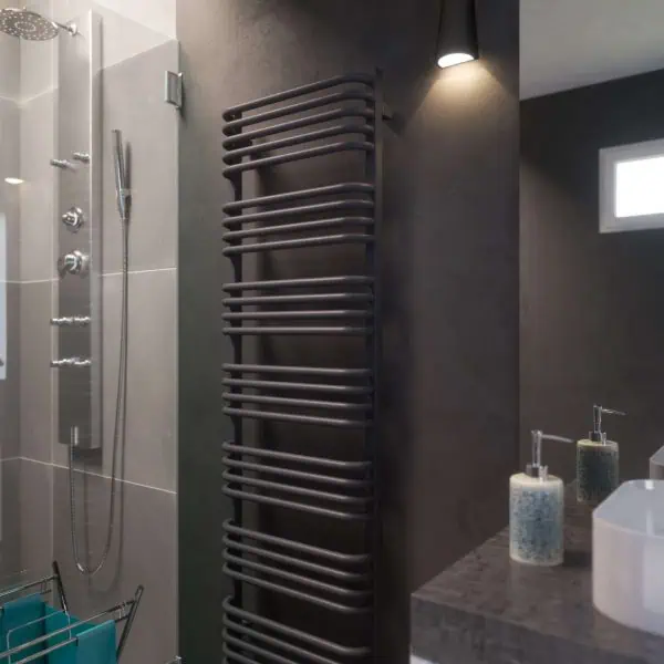 1. Modern black heated towel rail in contemporary bathroom with shower and sink.