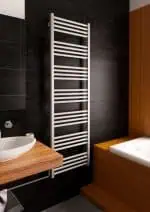Modern towel radiator heater in contemporary bathroom decor.