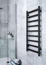 Wall-mounted black towel radiator for bathroom heating and drying.