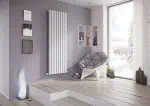 Modern radiator heater in stylish living room with minimalist decor, books, and large window.