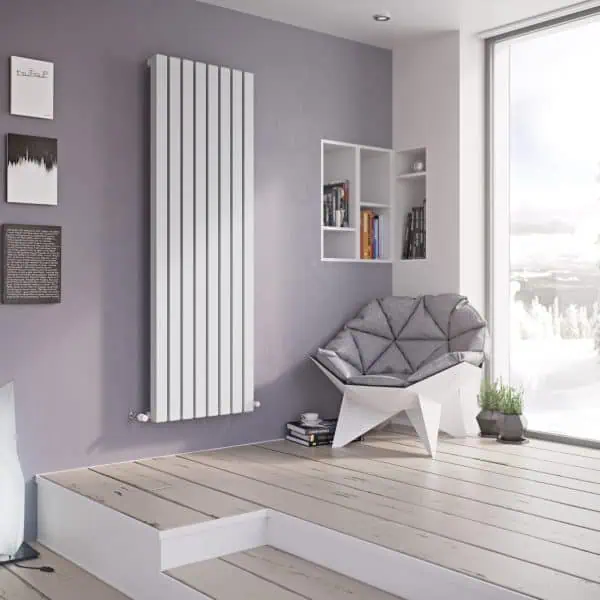Modern radiator heater in stylish living room with minimalist decor, books, and large window.