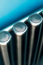 Stainless steel commercial radiator with perforated vents for efficient heating solutions.