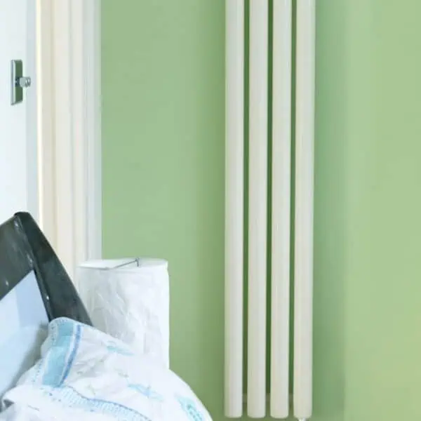 Radiator heating system in a modern bedroom with green wall - efficient home heating solutions.