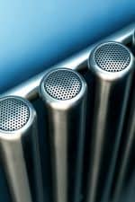 Stainless steel pipes with perforated covers, industrial plumbing components.