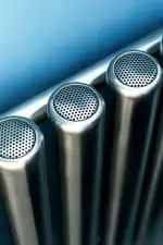 Stainless steel pipes with perforated covers, industrial plumbing components.