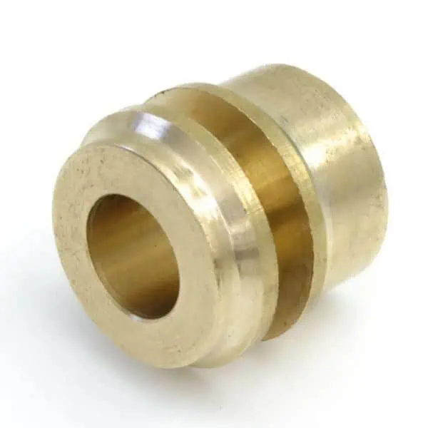 Gold metal wheel spacer for industrial machinery.