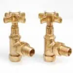 Brass water valves with cross handles and threaded connections for plumbing systems.