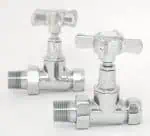 Shiny brass compression valves with cross handles for plumbing customization.