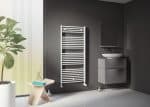 Modern bathroom with towel radiator, floating vanity, vessel sink, and stylish decor.