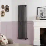 Vertical black column radiator for modern home heating.