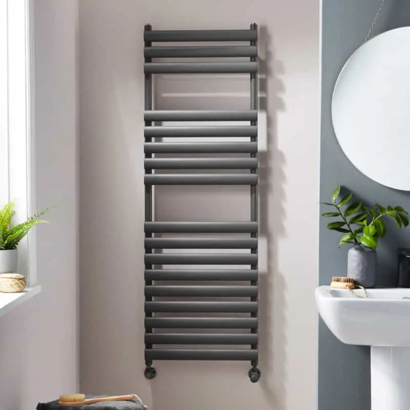 dorney Wall-mounted heated towel rail in modern bathroom, sleek black finish, space-saving design for warmth and towel drying.