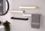 Sleek modern wall-mounted shelves in gold, black, and white for stylish bathroom or kitchen storage solutions.