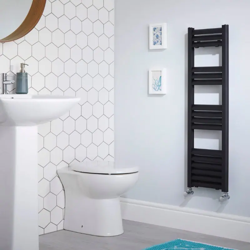 eton-anthracite Minimalist bathroom with white hex tile wall, wall-mounted black towel radiator, and modern fixtures.