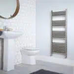 Hexagonal tile bathroom with modern sink, toilet, and heated towel rail Installation.