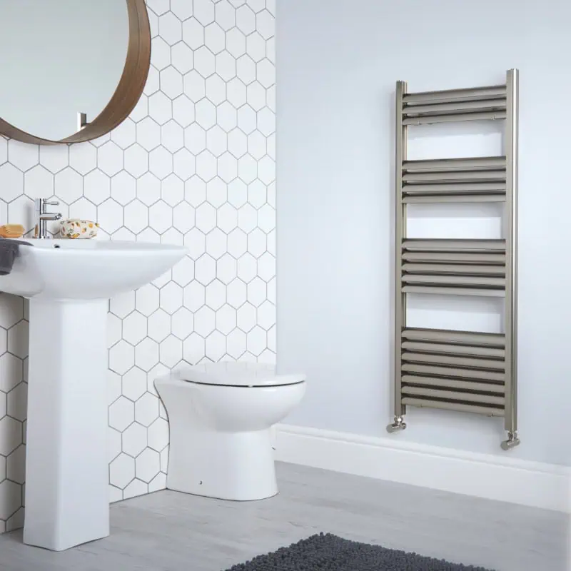 eton-brushed-aluminium Hexagonal tile bathroom with modern sink, toilet, and heated towel rail Installation.