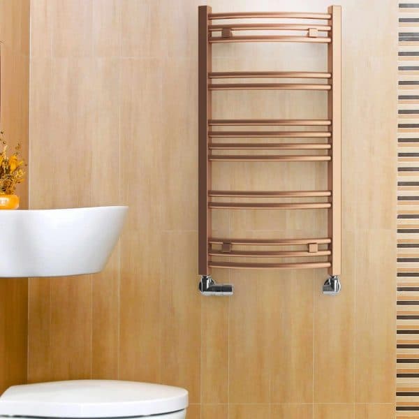 Chrome towel radiator in modern bathroom setting.