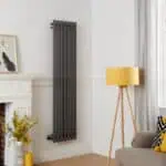 Black vertical radiator for modern home heating solutions.