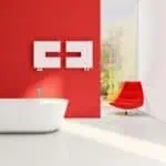 Modern bathroom with freestanding bathtub and stylish wall-mounted storage, bright red and white color scheme.