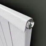 Radiator with chrome thermostat control for efficient home heating and temperature regulation.