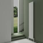 Aluminum vertical radiator heating panel in modern interior, energy-efficient wall-mounted design.