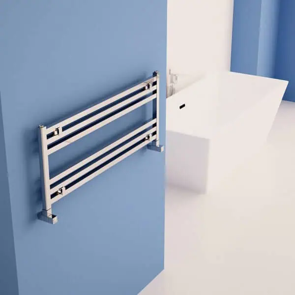 Modern heated towel rail in bathroom, sleek design with chrome finish.