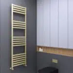 Contemporary beige towel radiator in a modern bathroom setting with blue cabinetry and textured gray wall.