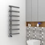 Sleek modern chrome towel radiator in a stylish bathroom setting.