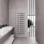 Contemporary bathroom with modern heated towel rail and minimalist design elements.
