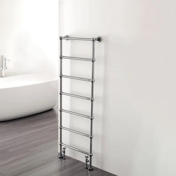 Stainless steel towel warmer radiator in modern bathroom.