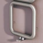 Aluminum handrail mounted on a pink textured wall, ideal for safety and support.