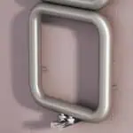 Aluminum handrail mounted on a pink textured wall, ideal for safety and support.