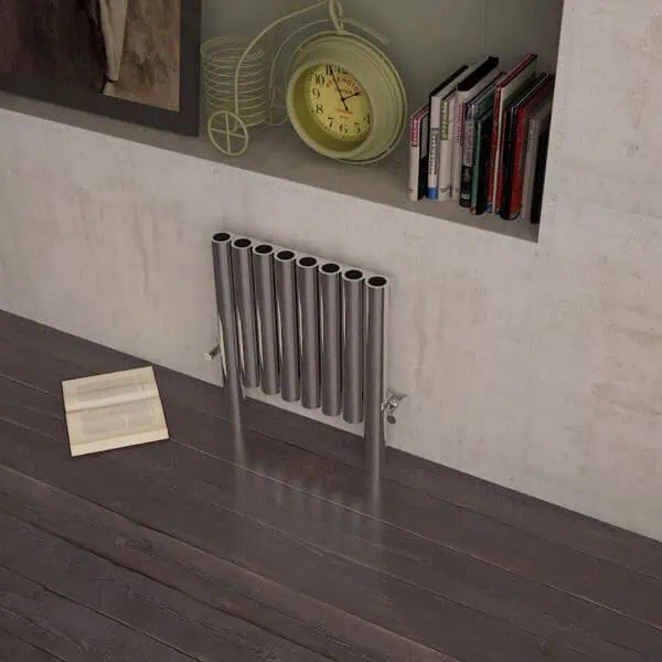Polished metal radiator with modern design in a contemporary room setting.