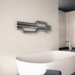 Futuristic towel warmer with sleek metallic design in modern bathroom setting.