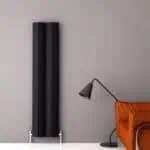 Modern black radiator heating panel in a stylish interior setting.