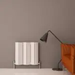 Modern radiator and floor lamp in stylish living room, cozy home decor setup.