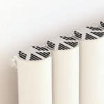 Modern white radiator with innovative black slatted design for efficient home heating.