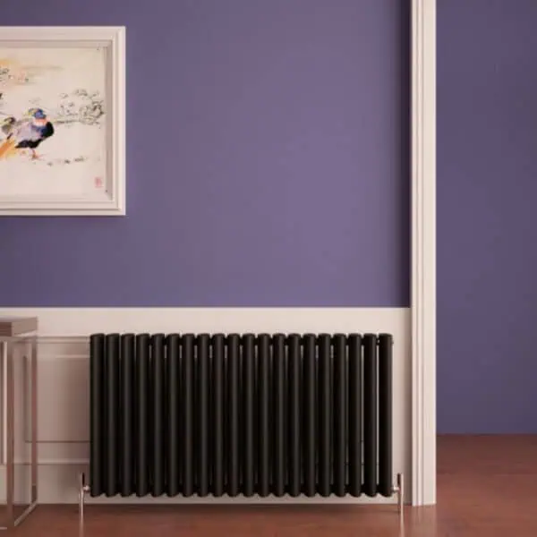 Black radiator heating panel in modern home interior.