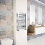 Modern bathroom with sleek stainless steel towel warmer and double washbasins, contemporary interior design.