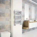 Modern bathroom with sleek stainless steel towel warmer and double washbasins, contemporary interior design.
