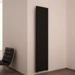 Sleek black vertical radiator in modern interior.