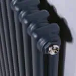 Efficient black cast iron radiator for central heating systems.