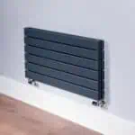 Modern horizontal black radiator for home heating solutions.