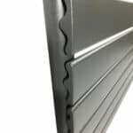 Machine shelving unit with durable metal slats for industrial storage solutions.