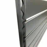 Machine shelving unit with durable metal slats for industrial storage solutions.